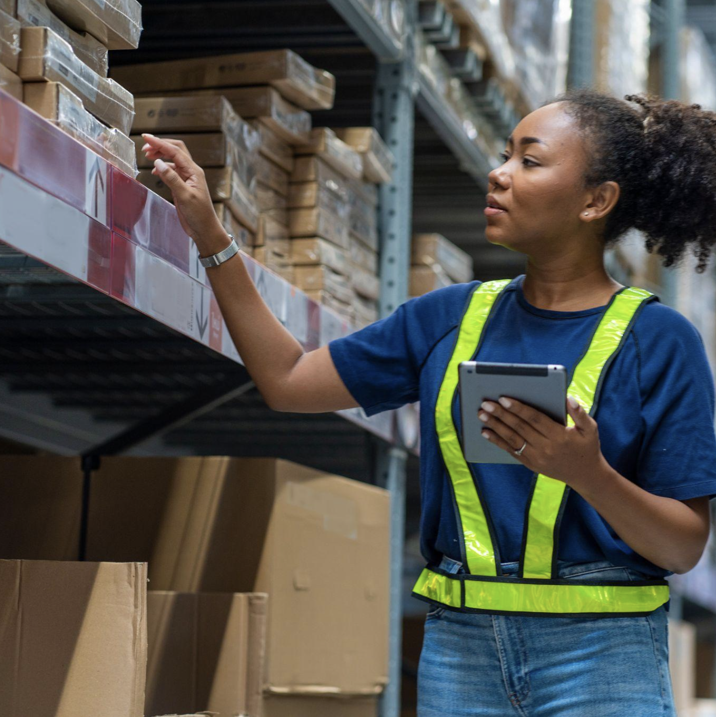 Quality inspector checking certificate of conformance paperwork against container labels at aviation receiving inspection