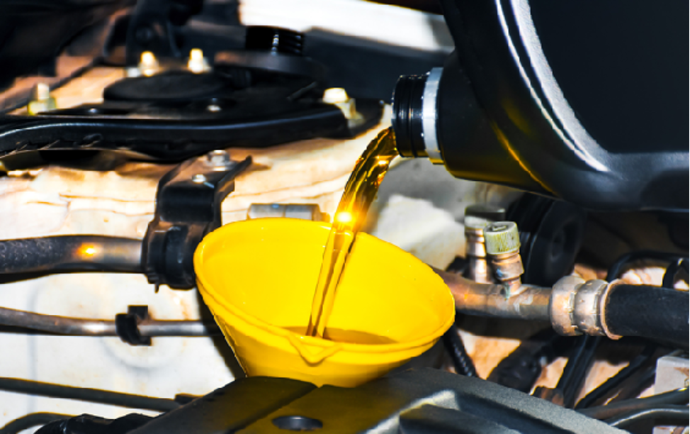 Pouring phosphate ester hydraulic fluid into an engine with a funnel